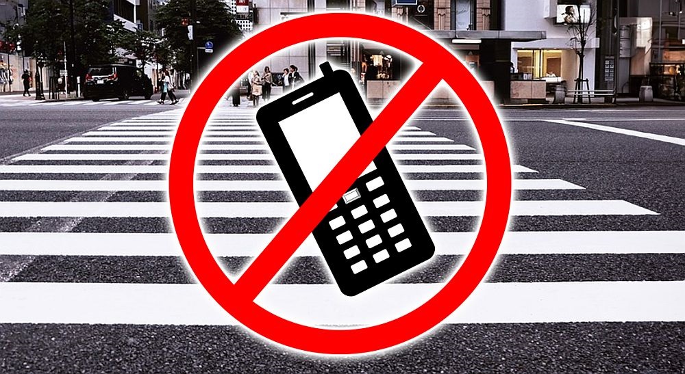 Policja ostrzega pieszych – 300 zł mandatu za korzystanie z telefonu przy przejściu