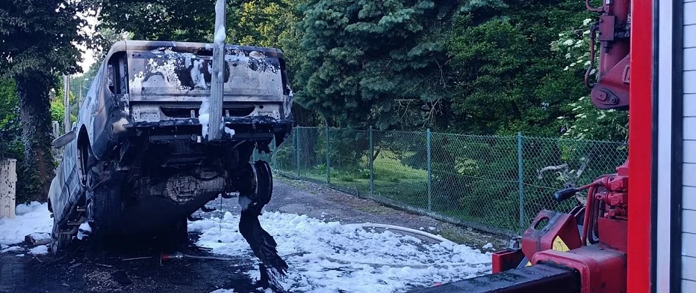 Pożar samochodu elektrycznego przed posesją. Strażacy musieli chłodzić baterię